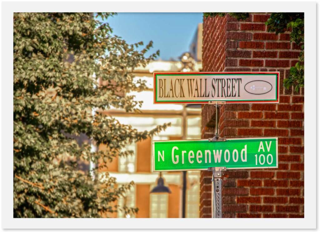 Signs pointing to Black Wall Street and N. Greenwood Ave in Tulsa, Okalahoma