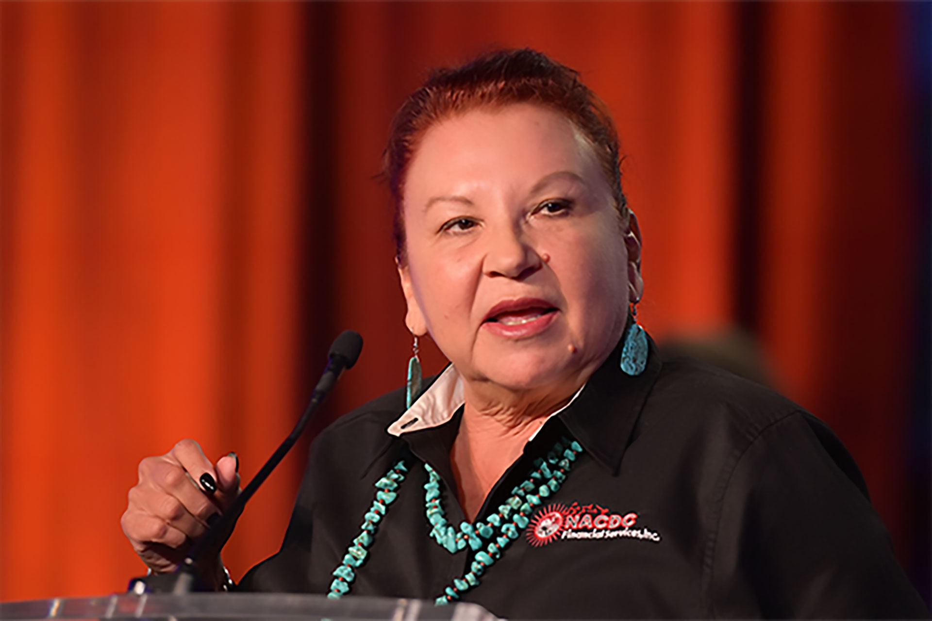 Angie Main accepts the 2023 Native CDFI award for the NACDC's unique strategies to advance finance justice in tribal communities.