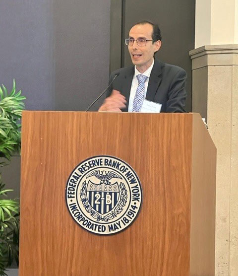 A man standing behind a podium speaking to an audience