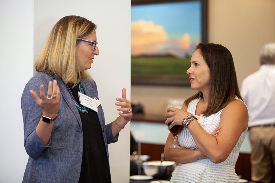 Two women networking at Investment Connection event in Denver