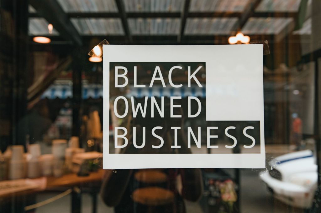 Black owned business sign on storefront
