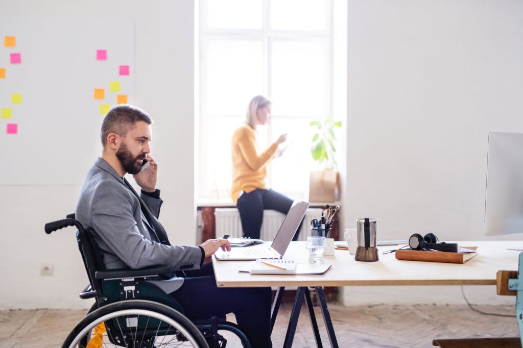 Man in wheelchair in office space