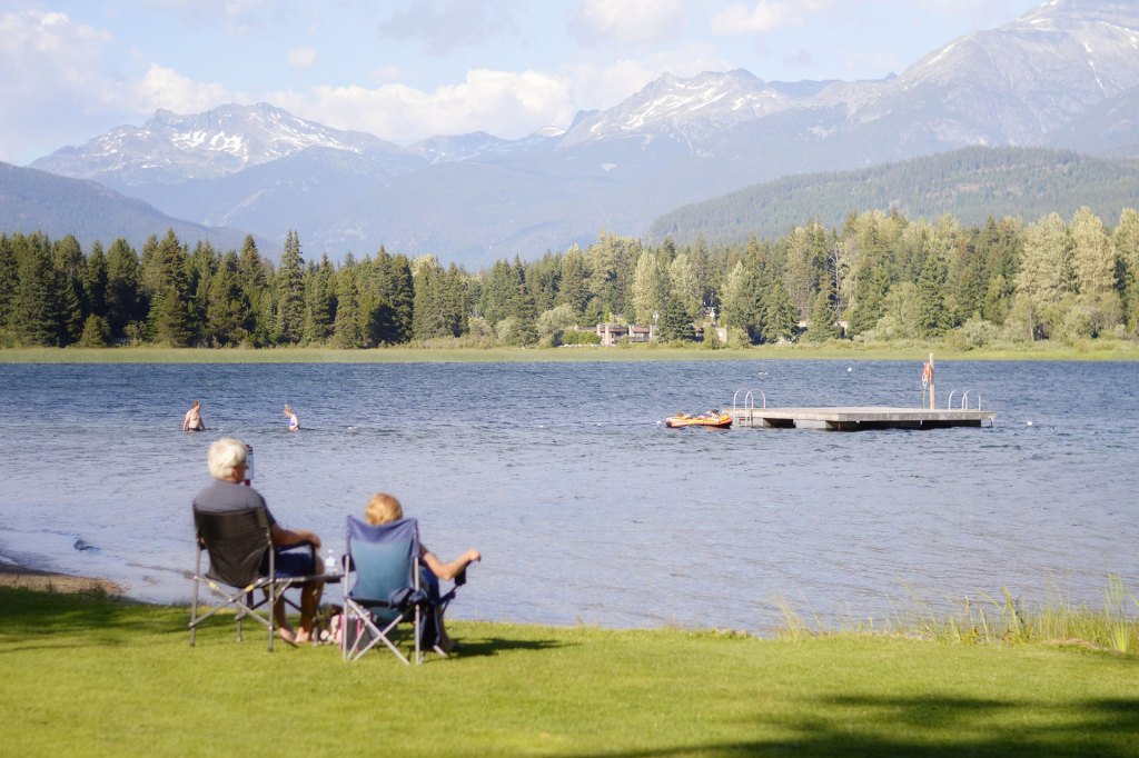 A retired couple watches Alta Lake in Whistler, Canada