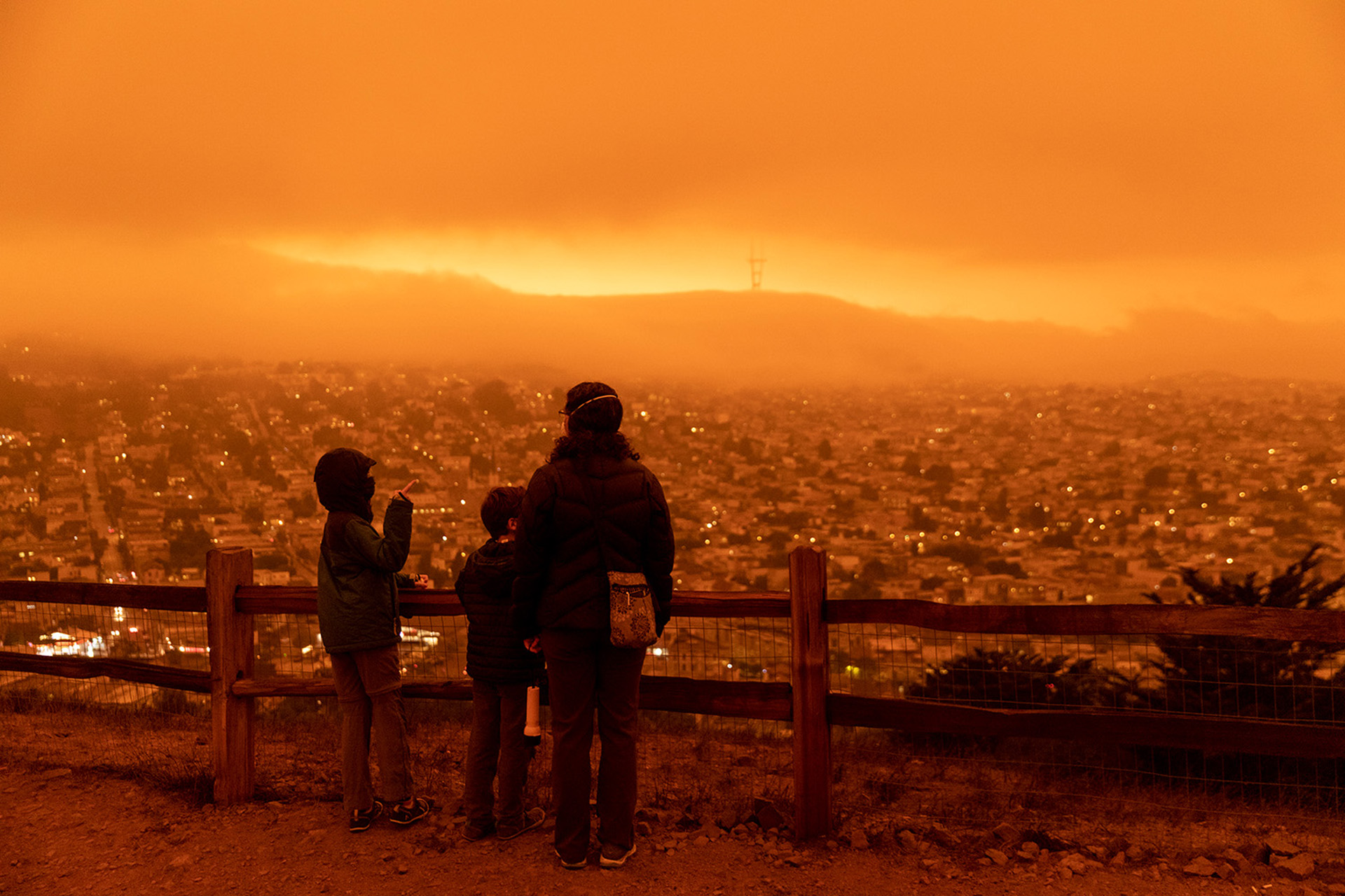 Mother and children looking over San Francisco with smoke in the air.