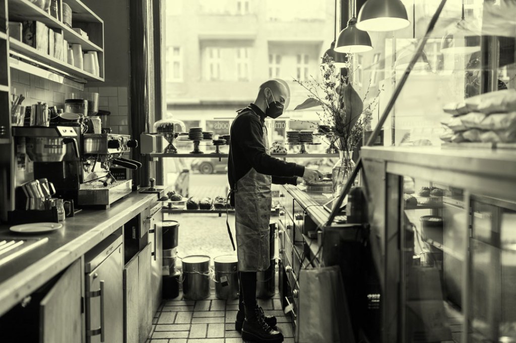 Man working at cafe during pandemic