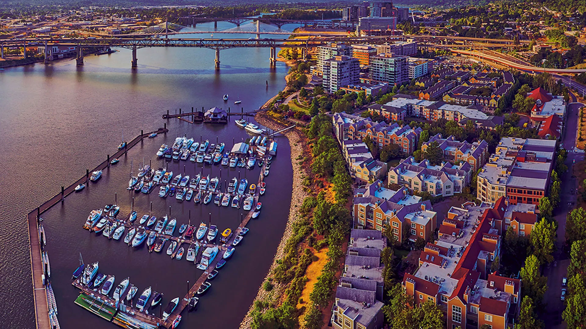 Aerial view of Portland, Oregon. Boats in a harbor with bridges and downtown in the background.