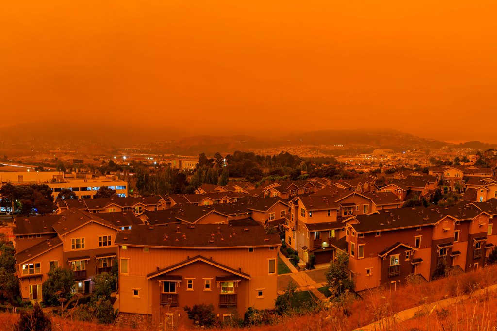 Thick orange haze above San Francisco on September 9, 2020 from record wildfires in California, daytime view of ash and smoke floating over the Bay Area