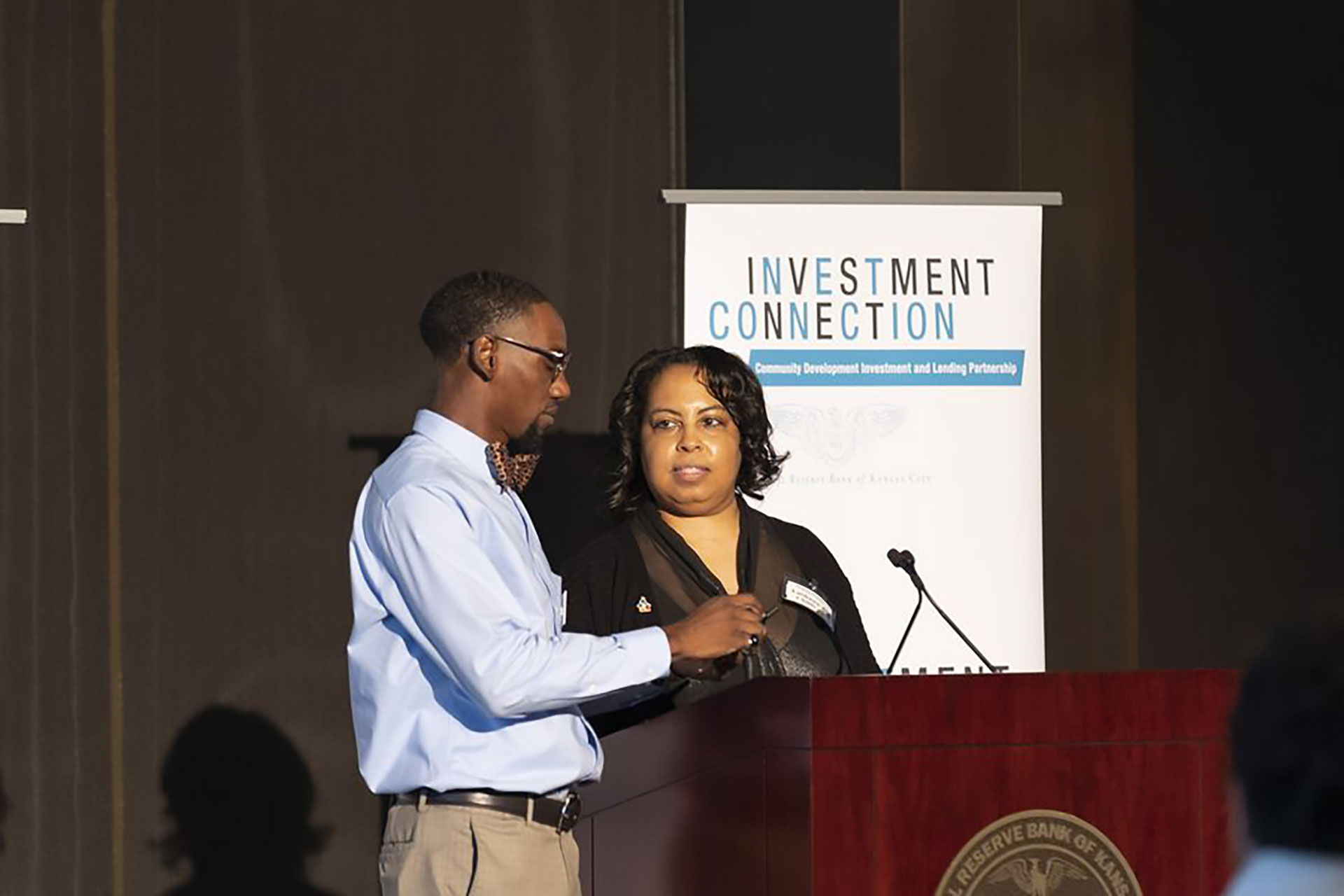 Two people standing together at an Investment Connection program at the Federal Reserve Bank of Kansas City Omaha branch.