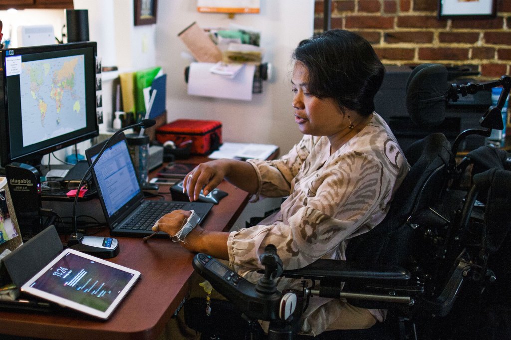 Person using voice assisted technology in an office setting.