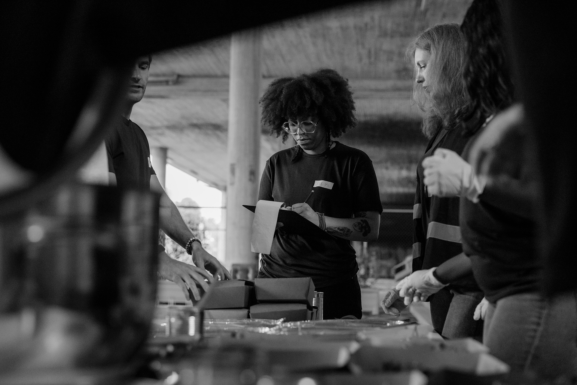 A group of factory workers tracking inventory.