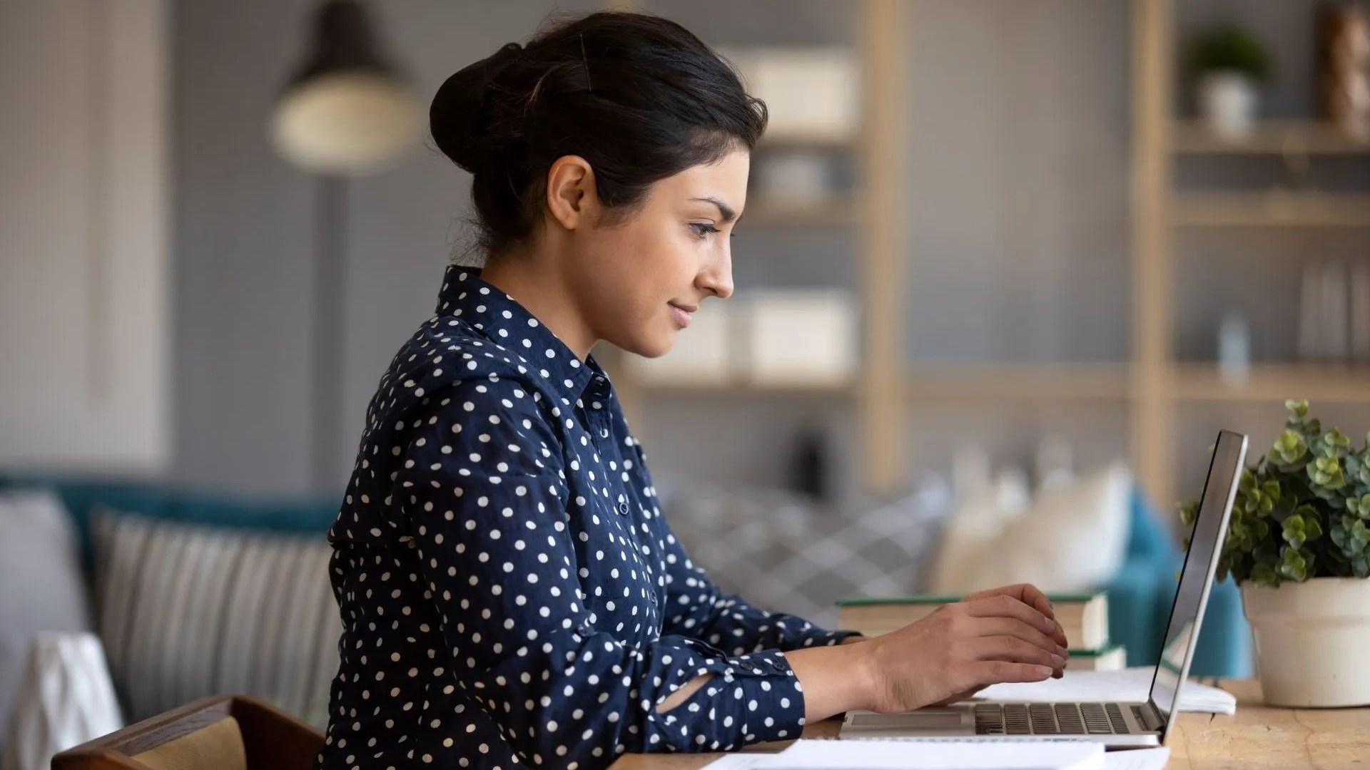 Woman sits at a computer exploring data 