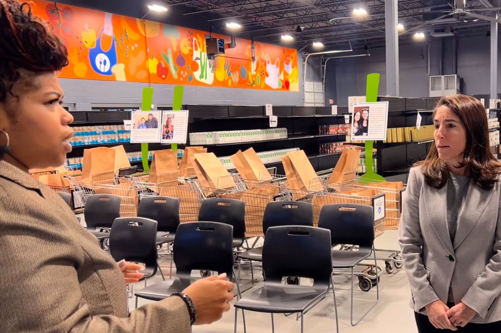 Two people chatting inside a foodbank