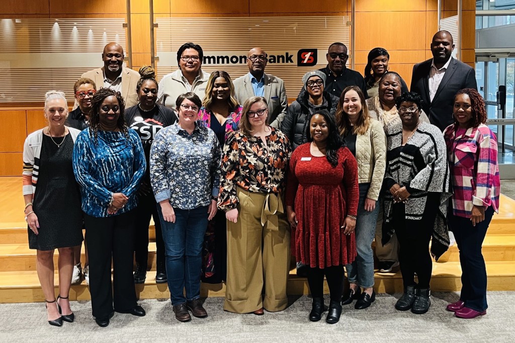 A group of people smiling after a Develop the Developer group meeting
