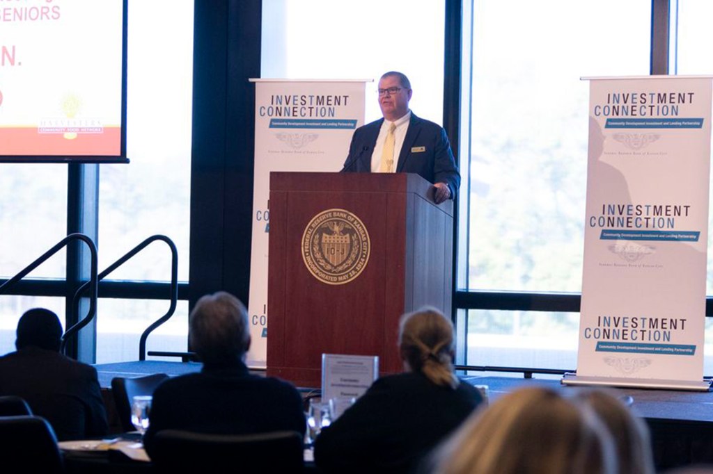 Person at a podium making a pitch at an Investment Connection event hosted by the Federal Reserve Bank of Kansas City