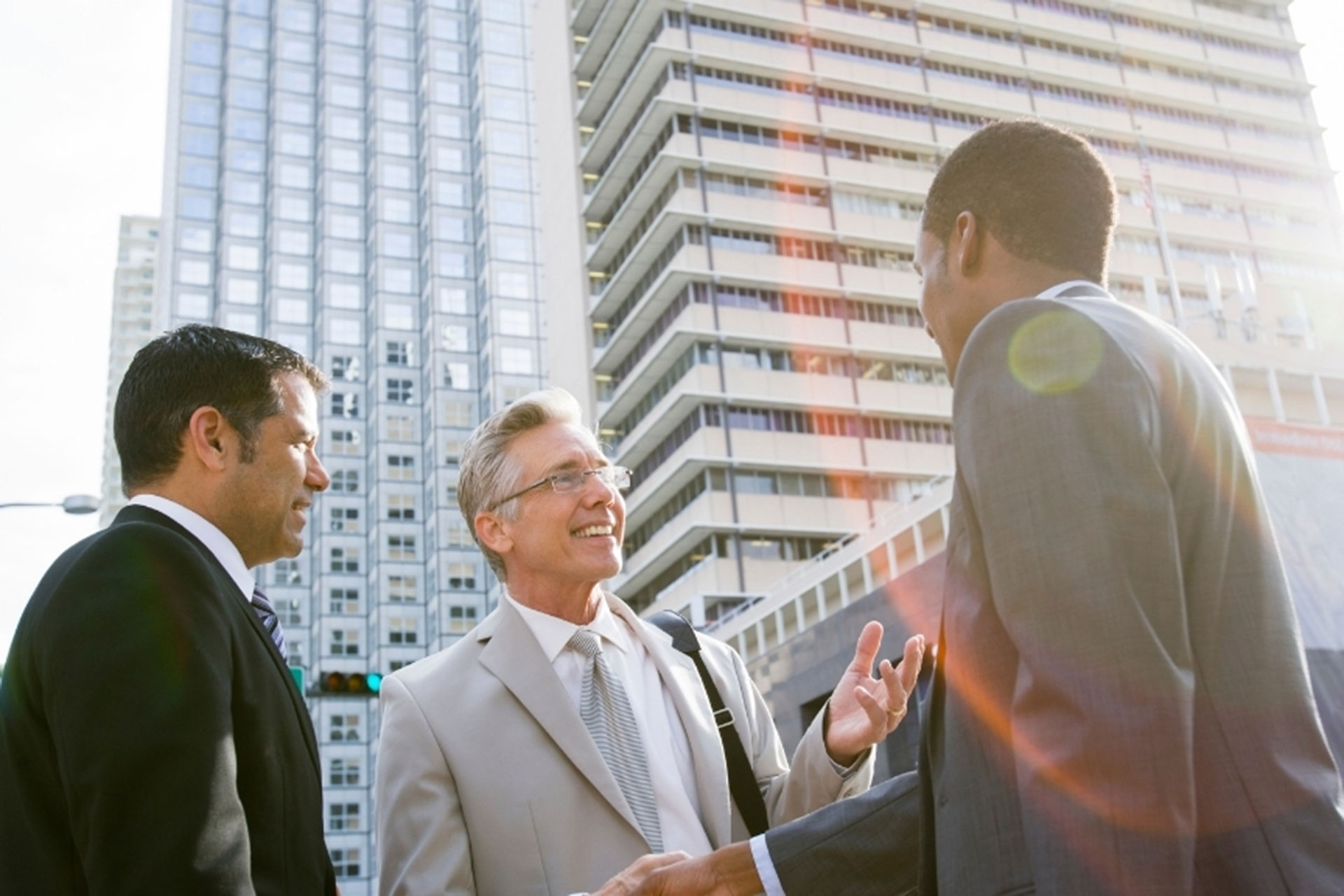 Three business men talking.