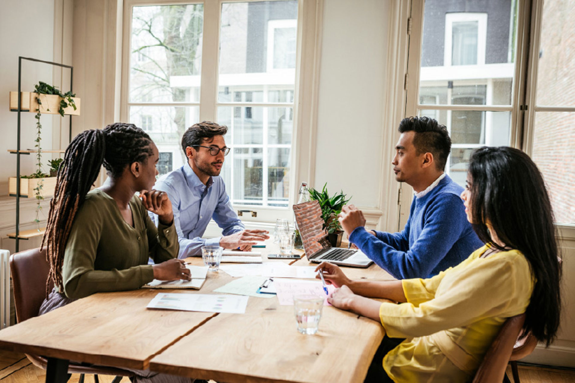 Group of diverse millennials business people, in the modern office developing start-up project for crowdfunding.